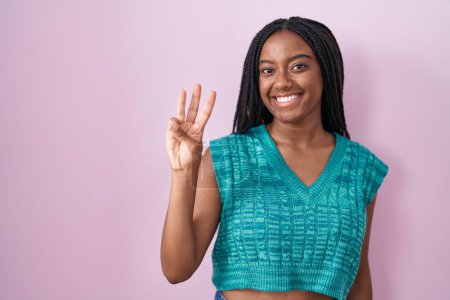 Photo for Young african american with braids standing over pink background showing and pointing up with fingers number three while smiling confident and happy. - Royalty Free Image