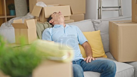 Photo for Middle age man relaxed on sofa at new home - Royalty Free Image