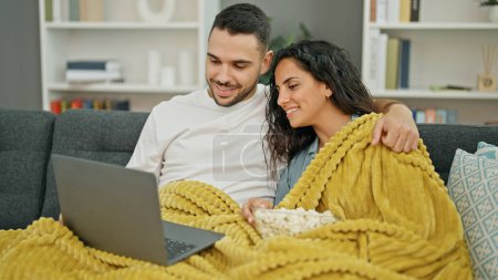 Foto de Hombre y mujer pareja viendo la película en el ordenador portátil en casa - Imagen libre de derechos