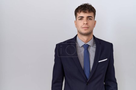 Photo for Young hispanic business man wearing suit and tie relaxed with serious expression on face. simple and natural looking at the camera. - Royalty Free Image