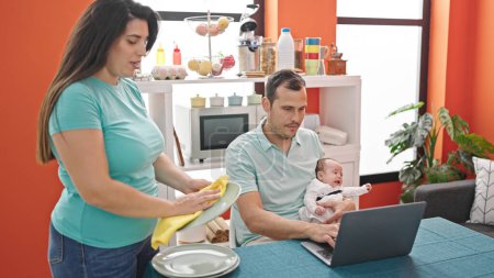 Photo for Young mother with her family using laptop at home - Royalty Free Image