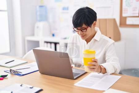 Photo for Middle age chinese woman business worker using laptop working at office - Royalty Free Image
