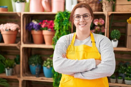 Photo for Young beautiful plus size woman florist smiling confident standing with arms crossed gesture at flower shop - Royalty Free Image