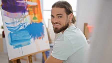Foto de Young hispanic man artist smiling confident drawing at art studio - Imagen libre de derechos