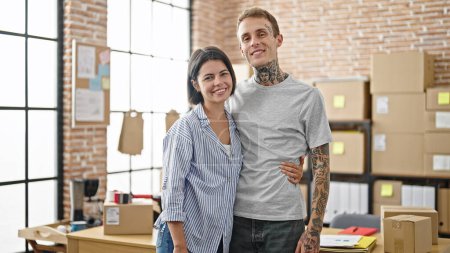 Photo for Two ecommerce business workers smiling confident hugging each other at office - Royalty Free Image