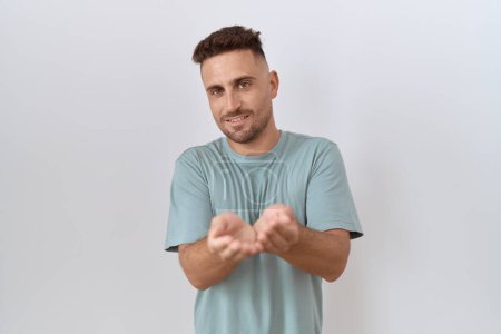 Photo for Hispanic man with beard standing over white background smiling with hands palms together receiving or giving gesture. hold and protection - Royalty Free Image