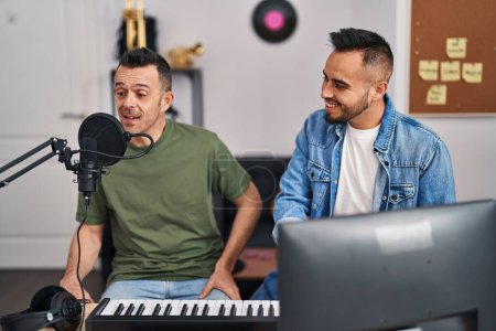 Photo for Two men musicians singing song playing piano at music studio - Royalty Free Image