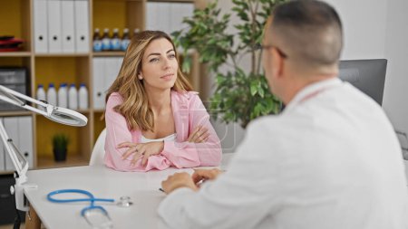 Photo for Man and woman doctor and patient having medical consultation at the clinic - Royalty Free Image