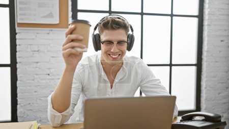 Photo for Young caucasian man business worker using laptop and headphones holding coffee at the office - Royalty Free Image