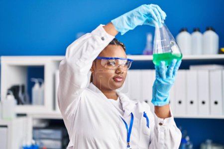 Photo for African american woman scientist holding test tube at laboratory - Royalty Free Image