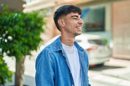 Photo for Young hispanic man smiling confident looking to the side at street - Royalty Free Image