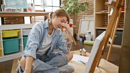 Photo for Young woman artist looking draw stressed at art studio - Royalty Free Image