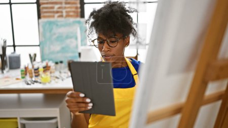 Photo for African american woman artist looking touchpad drawing at art studio - Royalty Free Image