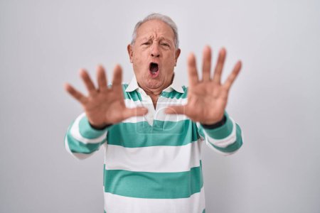 Photo for Senior man with grey hair standing over white background doing stop gesture with hands palms, angry and frustration expression - Royalty Free Image