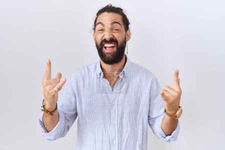 Photo for Hispanic man with beard wearing casual shirt shouting with crazy expression doing rock symbol with hands up. music star. heavy music concept. - Royalty Free Image