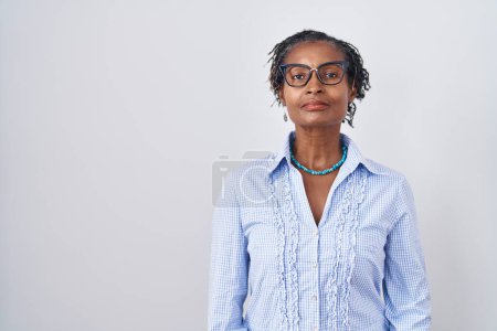 Photo for African woman with dreadlocks standing over white background wearing glasses relaxed with serious expression on face. simple and natural looking at the camera. - Royalty Free Image