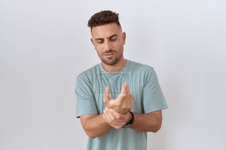 Photo for Hispanic man with beard standing over white background suffering pain on hands and fingers, arthritis inflammation - Royalty Free Image
