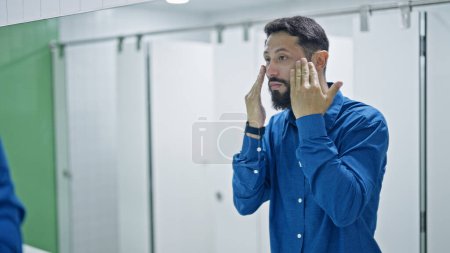 Photo for Young hispanic man washing face at bathroom - Royalty Free Image