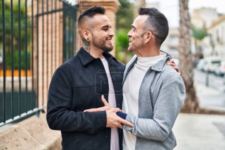 Téléchargez les photos : Two men couple smiling confident hugging each other at street - en image libre de droit