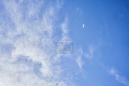 Photo for A tranquil sky with scattered wispy clouds and sunlight - Royalty Free Image