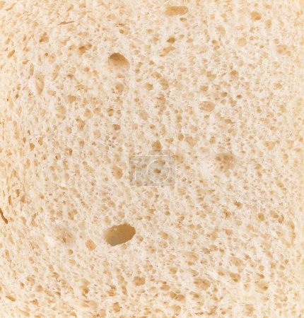 Foto de Vista de cerca de una rebanada de textura de pan blanco con poros visibles y miga suave. - Imagen libre de derechos
