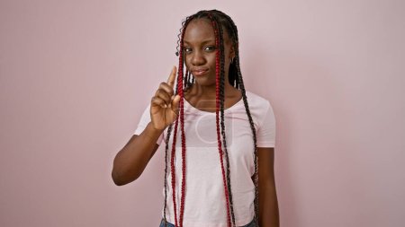 Foto de Cool africana americana mujer con confianza dice que no, dedo sobre rosa aislado fondo - expresión audaz de la negación - Imagen libre de derechos