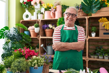 Photo for Middle age grey-haired man florist smiling confident standing with arms crossed gesture at flower shop - Royalty Free Image