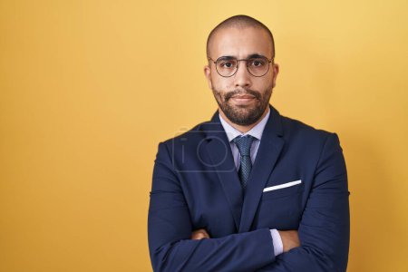 Photo for Hispanic man with beard wearing suit and tie skeptic and nervous, disapproving expression on face with crossed arms. negative person. - Royalty Free Image