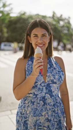 Photo for Summertime delight, beautiful hispanic woman enjoying delicious ice cream cone on a sunny day in nara, japan's luscious park, her cheerful smile reflecting holiday fun and outdoor adventures - Royalty Free Image