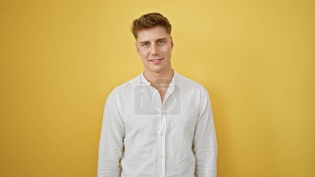 Laughing, confident young caucasian man in casual fashion, standing isolated against a yellow background, radiating positive vibes and joy