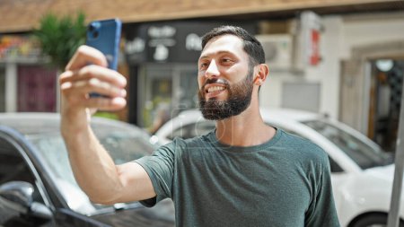 Photo for Young hispanic man smiling confident having video call at street - Royalty Free Image