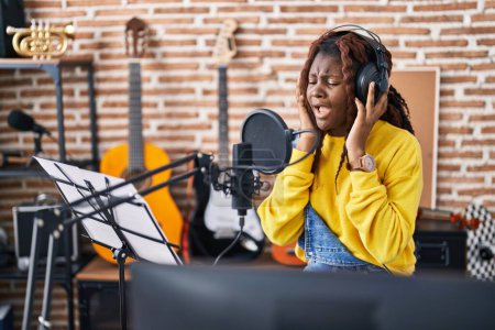 Foto de Músico afroamericano cantando canción en estudio de música - Imagen libre de derechos