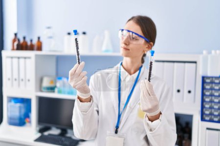 Photo for Young caucasian woman scientist holding test tubes at laboratory - Royalty Free Image