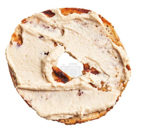Foto de Primer plano de un bagel de pasas de canela tostado con queso crema sobre fondo blanco. - Imagen libre de derechos
