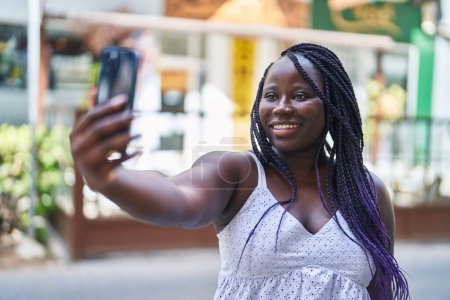 Photo for African american woman smiling confident making selfie by the smartphone at street - Royalty Free Image