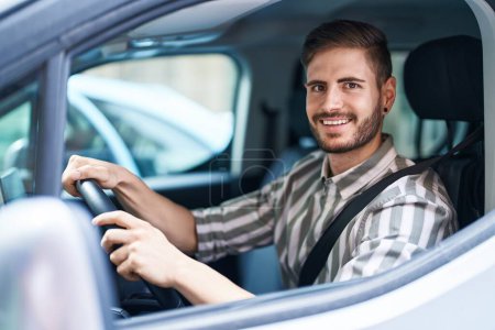 Photo for Hispanic man with beard driving car looking positive and happy standing and smiling with a confident smile showing teeth - Royalty Free Image