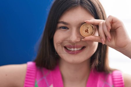 Photo for Young caucasian woman smiling confident holding uniswap coin over eye at home - Royalty Free Image