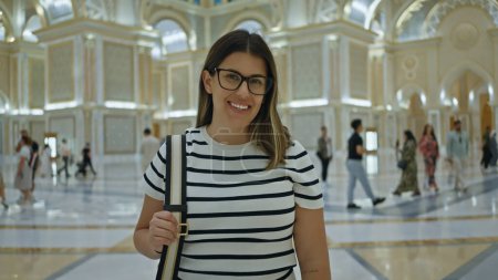 Photo for Smiling woman with glasses inside ornate qasr al watan palace in abu dhabi - Royalty Free Image