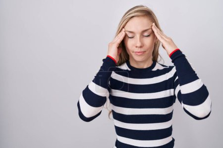 Photo for Young caucasian woman wearing casual navy sweater with hand on head for pain in head because stress. suffering migraine. - Royalty Free Image