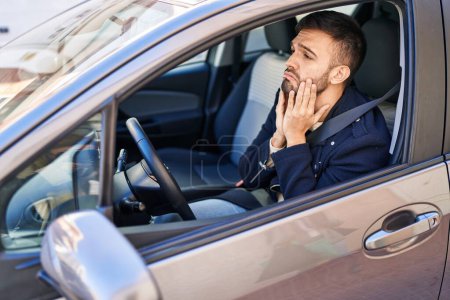 Photo for Young hispanic man stressed driving car at street - Royalty Free Image