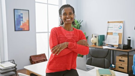 Photo for Confident african american woman in a bright office, smiling at the camera, work environment, professional, mature, interior - Royalty Free Image