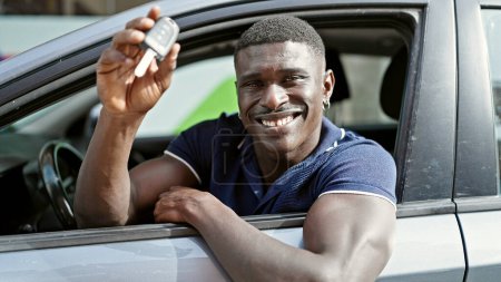 Photo for African american man smiling confident holding key of new car at street - Royalty Free Image