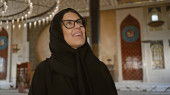 Smiling woman wearing hijab inside ornate doha mosque with arabesque design and lights puzzle #699243524