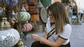 A young hispanic woman explores traditional lighting at souq waqif in doha, displaying culture and tourism. Longsleeve T-shirt #699244892
