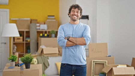 Photo for Young hispanic man smiling confident standing with arms crossed gesture at new home - Royalty Free Image