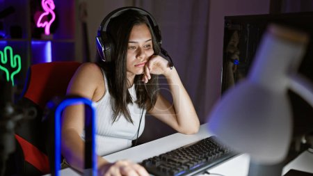 Photo for Young beautiful hispanic woman streamer tired using computer at gaming room - Royalty Free Image