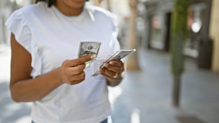 Photo for African american woman holding us dollars outside - Royalty Free Image