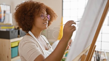 Photo for Two artists, partners in art and life, seriously engrossed in their craft, painting and drawing at a cozy art studio, learning, expressing creativity on canvas with brushes and palette. - Royalty Free Image