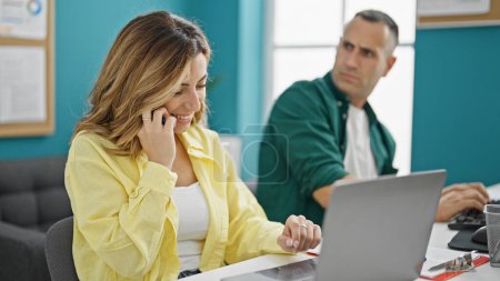 Photo for Man and woman business workers talking on smartphone while work at the office - Royalty Free Image
