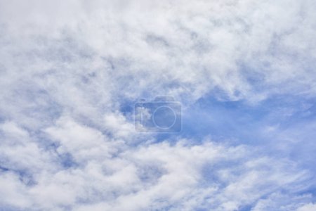A tranquil image capturing soft white clouds against a serene blue sky, symbolizing peace and tranquility in nature.